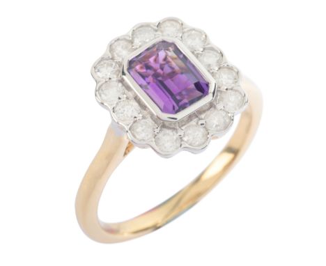 AN AMETHYST AND DIAMOND CLUSTER RINGin 9ct gold, set with a step cut amethyst of c.0.86 carats, surrounded by a cluster of ro