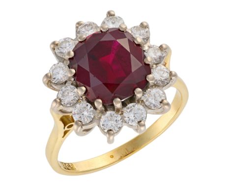 A RUBY AND DIAMOND CLUSTER RINGin 18ct gold, set with a cushion cut ruby of c.3.52 carats, surrounded by a cluster of round b
