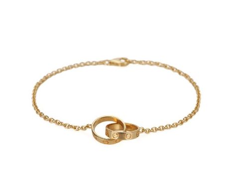 CARTIER: A 'LOVE' CHAIN BRACELETin 18ct gold, comprising two interlocking rings with screw motifs, to a trace link chain, sec