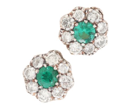 A PAIR OF EMERALD AND DIAMOND CLUSTER STUD EARRINGSin silver on 18ct gold, each set with a round cut emerald, surrounded by a