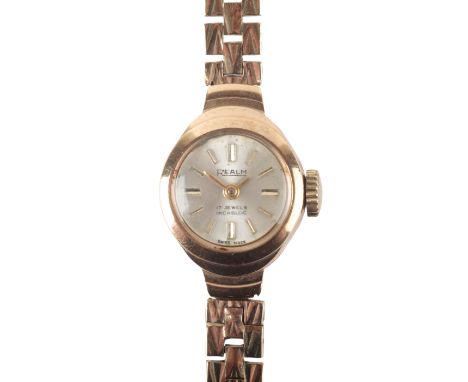 REALM: A 9CT GOLD BRACELET WATCHwith manual wind movement, the silver dial with gold baton numerals and gold hands, inscribed