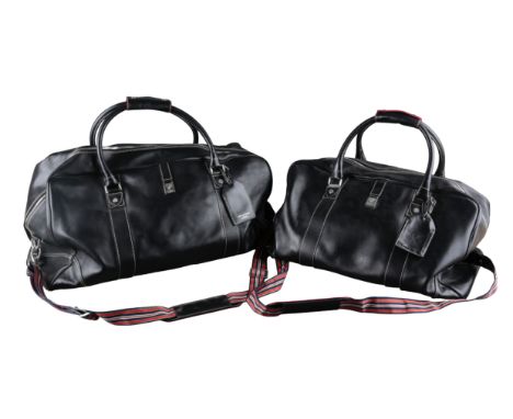 AN ASPINALL OF LONDON BLACK LEATHER FOUR PIECE LUGGAGE SETwith red, black and white straps and chromed mounts, comprising two