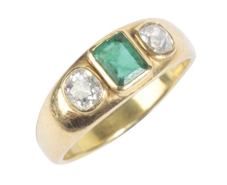 EMERALD AND DIAMOND THREE STONE RINGin 18ct gold, set with a step cut emerald of c.0.70 carats, flanked by old cut diamonds t