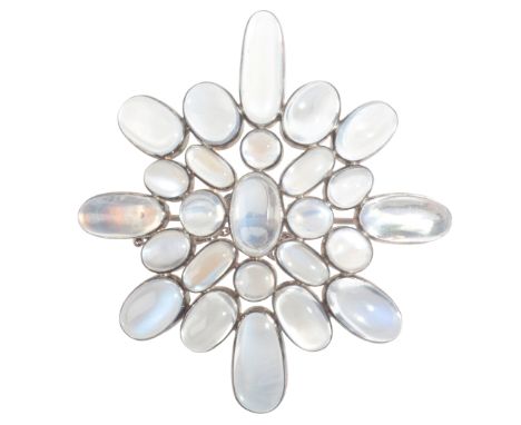 A MOONSTONE BROOCHin sterling silver, set with moonstone cabochons, secured with a hinged pin clasp and safety chain, stamped