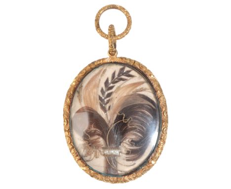 A FINE ANTIQUE VICTORIAN MOURNING PENDANTin gilt metal, with ornate engraved detailing, containing a daguerreotype of a Victo