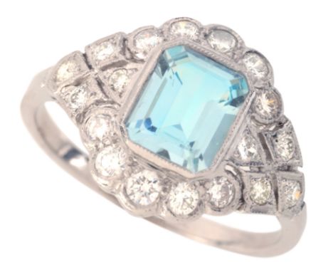 AN AQUAMARINE AND DIAMOND DRESS RING&nbsp;in platinum, set with a step cut aquamarine of c.1.43 carats, surrounded by a clust