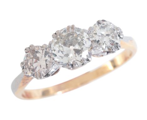 A DIAMOND THREE STONE RINGin 18ct gold and platinum, set with three graduated old European cut diamonds, totalling c.1.1-1.2 