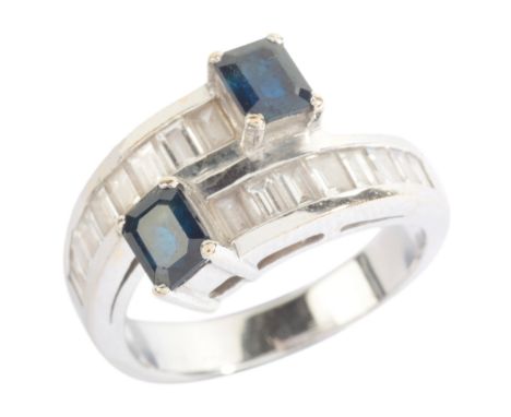A SAPPHIRE AND DIAMOND TOI-ET-MOI RINGin 18ct white gold, in a cross-over design, channel-set with baguette cut diamonds tota