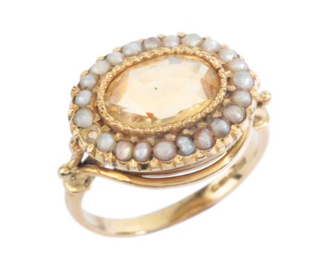 A VINTAGE CITRINE AND PEARL CLUSTER RINGin 18ct gold, set with an oval cut citrine, surrounded by a border of seed pearls, to