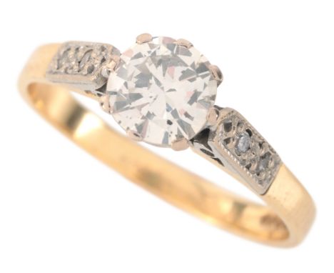 A DIAMOND SOLITAIRE RING in 18ct gold and platinum, set with a round brilliant cut diamond of c.0.80 carats, to diamond-set s
