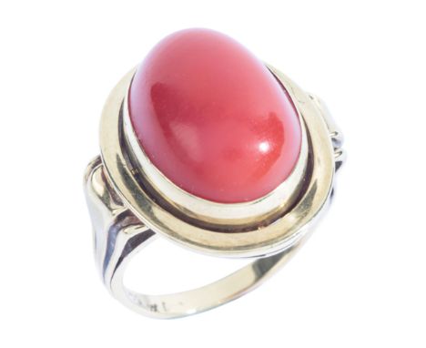 A RETRO CORAL RINGin 14ct gold, set with a coral cabochon of c.10.38 carats, to stylised shoulders, stamped '585', size N1/2 