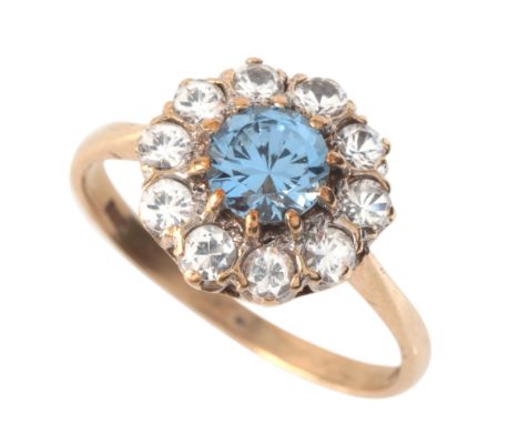 A VINTAGE SYNTHETIC SPINEL CLUSTER RINGin 9ct gold, set with a synthetic blue spinel of c.0.85 carats, surrounded by a cluste