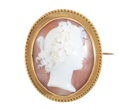 A FINE ANTIQUE CAMEO BROOCHin 9ct gold, set with a helmet shell, carved to depict the profile of a classical woman, surrounde