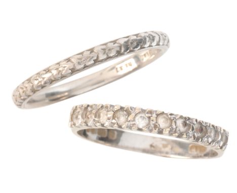 A PLATINUM WEDDING BANDwith engraved detailing to the outside edge, stamped 'PLATINUM', size N / 54; together with a paste ha