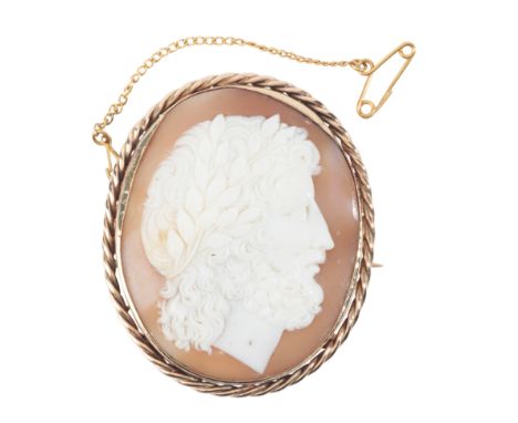 A CAMEO BROOCHin 9ct gold, set with a helmet shell, carved to depict the profile of a classical man, surrounded by a stylised