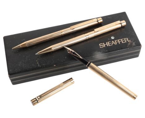 A SHEAFFER GOLD PLATED THREE PIECE SETcomprising fountain pen with 14k nib, ball pen and propelling pencil, each 13.5cm long,