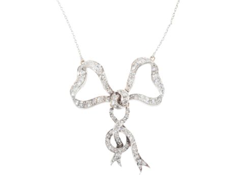 A DIAMOND BOW PENDANT NECKLACEin silver on gold, designed as a stylised bow with articulated ribbon drops, set throughout wit