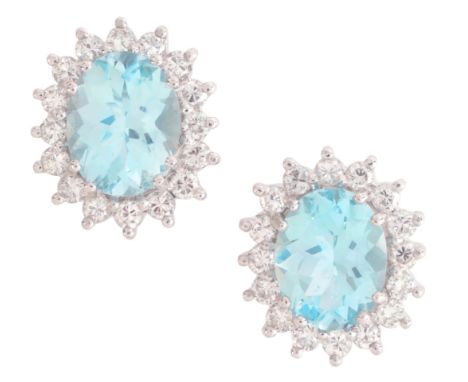 A PAIR OF AQUAMARINE AND DIAMOND CLUSTER STUD EARRINGSin 14ct white gold, each set with an oval cut aquamarine of c.1.39 and 