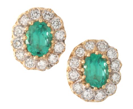 A PAIR OF EMERALD AND DIAMOND CLUSTER EARRINGSin 18ct gold, each set with an oval cut emerald, of c.0.90 carats respectively,