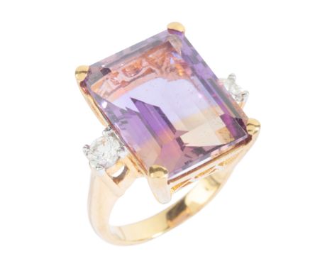 AN AMETRINE AND DIAMOND THREE STONE RINGin 18ct gold, set with a step cut ametrine of c.14.20 carats, flanked by round brilli