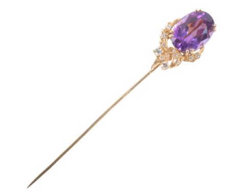 AN AMETHYST AND DIAMOND STICK PINin 18ct gold, set with an oval cut amethyst over a stylised design set with single cut diamo