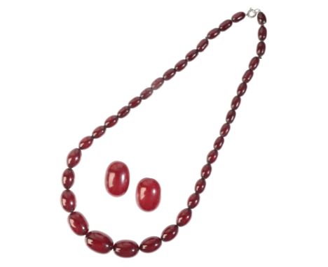 A CHERRY AMBER BEAD NECKLACEcomprising a series of cherry bakelite beads graduating from 1.3cm-2.4cm, secured with a bull rin