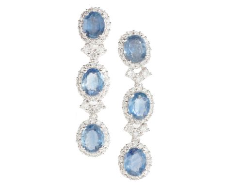 A PAIR OF SAPPHIRE AND DIAMOND DROP EARRINGSin platinum, each comprising a row of oval cut sapphires, accented throughout by 