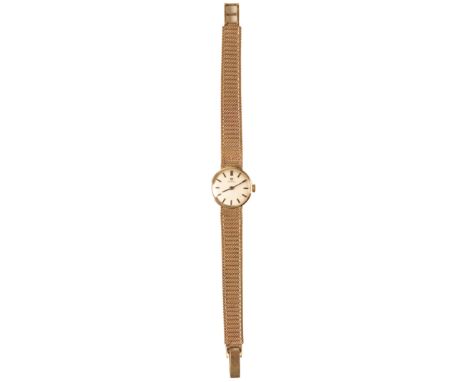 OMEGA: A 9CT GOLD  BRACELET WATCHwith manual wind movement, the silver dial with gold baton numerals and dark blue steel hand