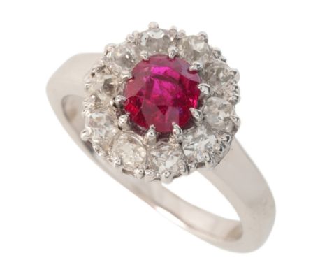 A RUBY AND DIAMOND CLUSTER RINGin 18ct white gold, set with a cushion cut ruby of c.0.90 carats, surrounded by a cluster of o