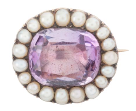 AN ANTIQUE AMETHYST AND PEARL BROOCHin 15ct gold, set with a cushion cut amethyst, held in a closed-back setting, surrounded 
