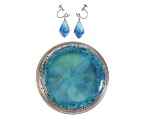 JOHN WILLIAM GILBERT: A RUSKIN POTTERY BROOCHin sterling silver, set with a blue and green glazed roundel held in a stylised 