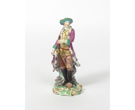 A Chelsea figure of a huntsman, c.1758-60, standing and holding the barrel of his gun in his left hand, a game bird in his ri