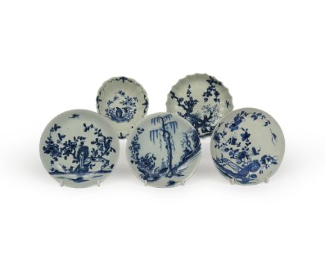 Four Worcester blue and white saucers, c.1757-60, painted in the Landslip, Rock Warbler, Prunus Fence and Prunus Root pattern