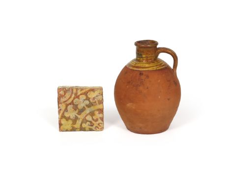 A medieval encaustic tile, 13th/14th century, decorated in cream slip with a formal radiating leaf design, and an 18th centur