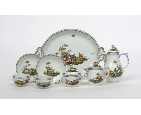 A Berlin tête à tête tea set, 19th century, painted with scenes of farmyard animals including sheep, cattle and goats, within