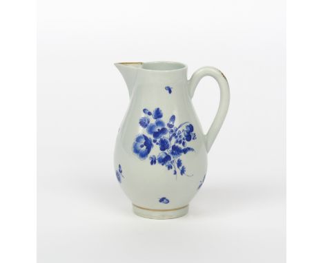 A Worcester milk jug, c.1780, painted in dry blue with sprays of flowers and single scattered leaves, the spout with a gilt d