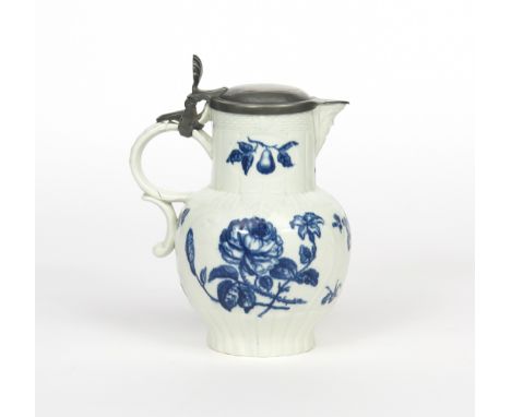 A Caughley blue and white mask jug, c.1780, printed with naturalistic flower sprays of rose and other blooms, moulded with le