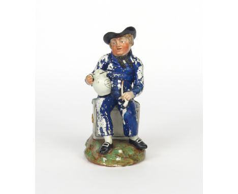 An American Sailor toby jug, c.1820, seated on a sea chest inscribed 'Dollars', holding a foaming jug bearing the legend 'Suc