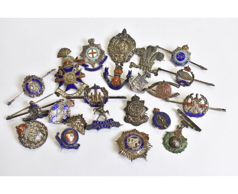 A collection of 22 silver and enamel Regimental pin badges, all marked silver or sterling, including Royal Kent West, Royal M