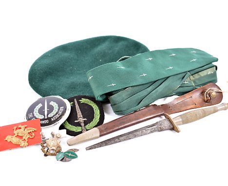 A collection of Commando related items, to include a Wilkinson Fairbairn Sykes dagger and scabbard (af), a pair of silver and