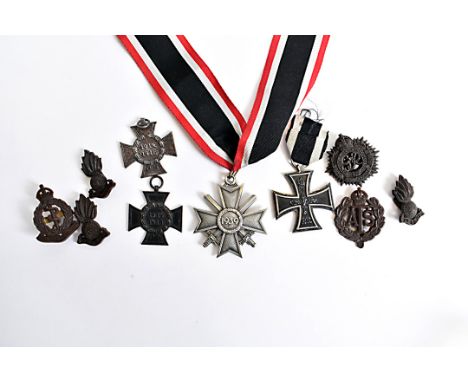 A Knight's Cross of the War Merit Cross with Swords, marked L/58 to the hanger ring, together with an Iron Cross and two Hind