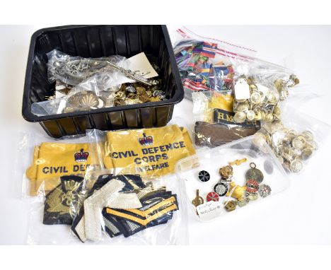 A large collection of badges and buttons, to include staybrights, cloth, bullion and earlier examples, a pair of spurs, a Roy