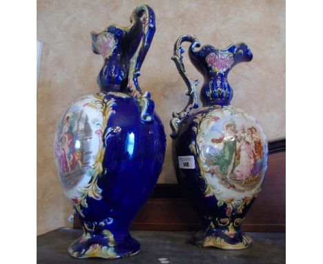 A Pair of Late 19th Century Majolica Ewers, transfer print highly decorated. 40cm high.