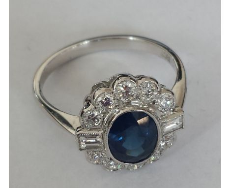 An 18ct. Gold Diamond and Sapphire Cluster Ring. Size O. Sapphire 1 carat, Diamond 0.9 carat approx.