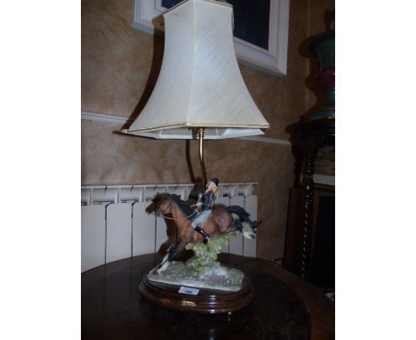 A Capodimonte Table Lamp modelled as a maiden on horseback, resin, on oval wooden base, with shade.