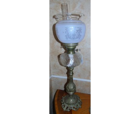 A Brass Paraffin Lamp, with frosted glass shade in the Victorian style.