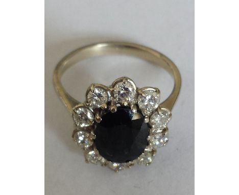 An 18ct. Gold Diamond and Sapphire Cluster Ring. Size M. Sapphire 2 carat, Diamond 1 carat approx.