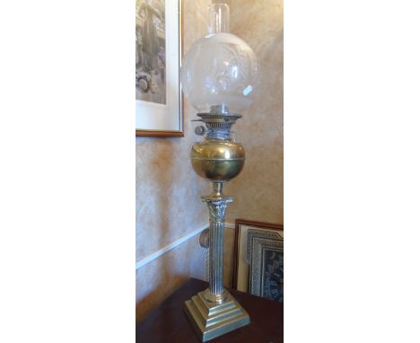 A Brass Oil Lamp, raised on a Corinthian column and stepped square base.