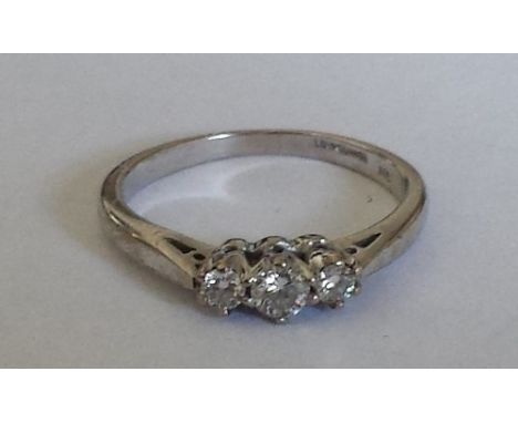 An 18ct. Diamond Three Stone Ring, approx .25 carat diamond weight. Size L.