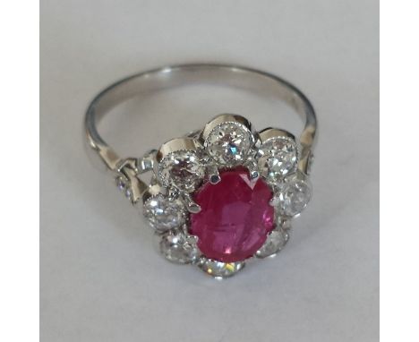 An 18ct. White Gold Diamond and Ruby Ring. Size N. Ruby 1.5 carat, Diamond 1.2 carat (approx).